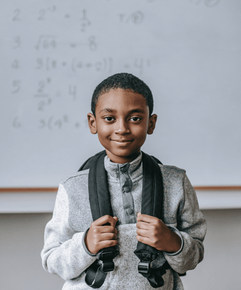 a young boy backing a school bag